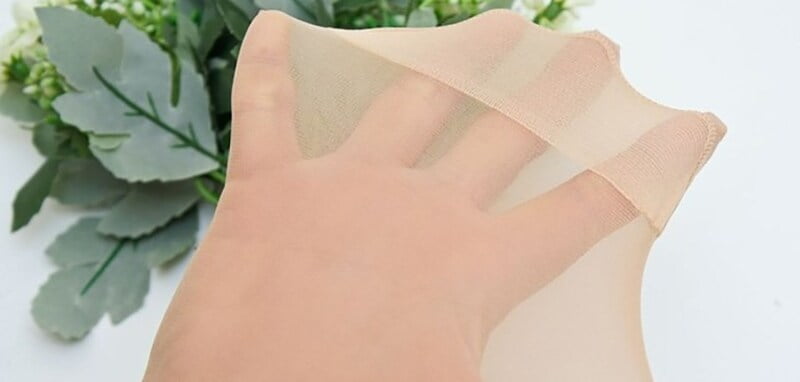 Làm sạch bụi vải trên quần áo đen bằng quần tất cũ.